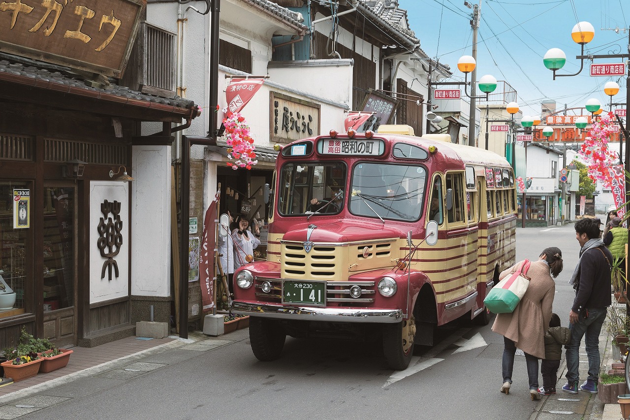 昭和の町商店街を走る赤いレトロバス